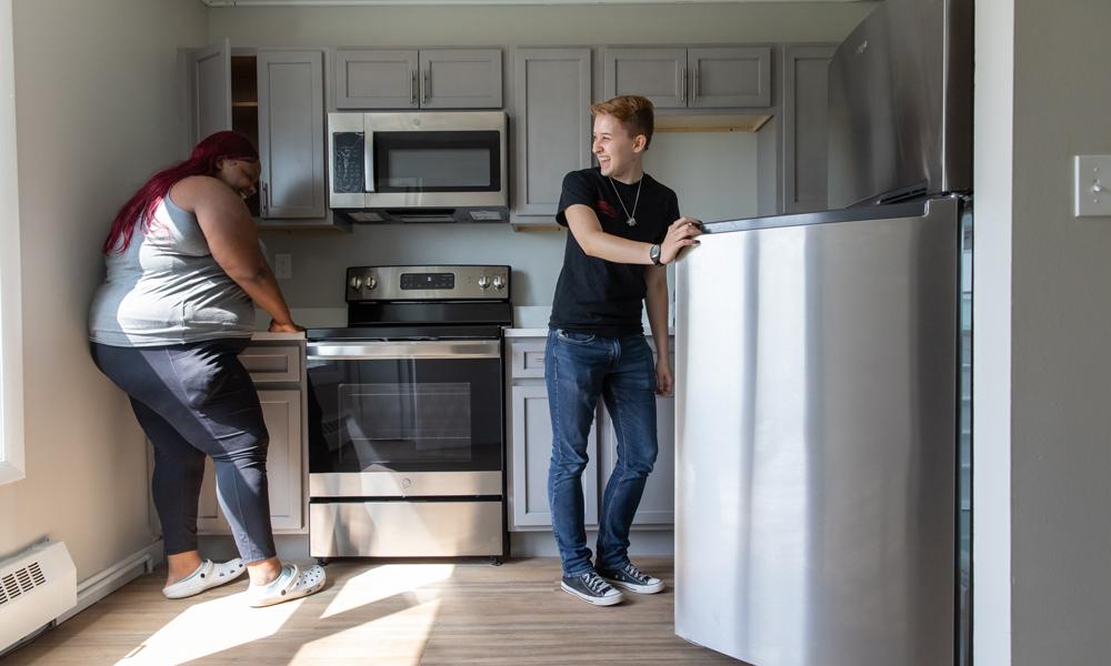 Students standing in remodeled kitchen